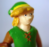 A portrait of a crude vinyl figure of Link with a vacant look on its face.