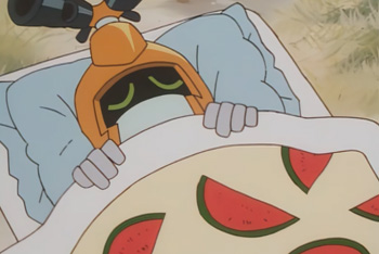 Metabee cozied up under a watermelon-patterned blanket and taking a nap.